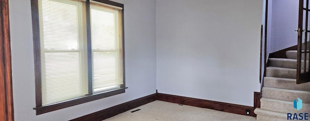 120 Main St, Scotland, SD 57059 - spare room featuring baseboards, stairs, and carpet