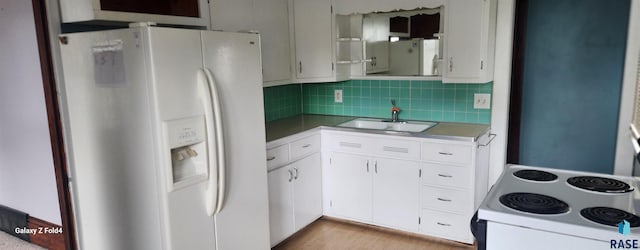 120 Main St, Scotland, SD 57059 - kitchen featuring white appliances, a sink, white cabinetry, tasteful backsplash, and light countertops
