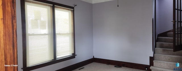 120 Main St, Scotland, SD 57059 - carpeted empty room featuring baseboards and stairs