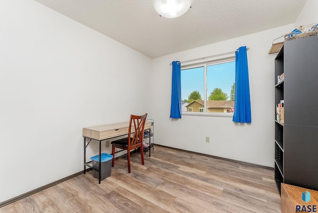 home office featuring wood finished floors and baseboards