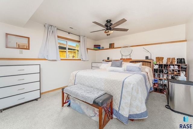 carpeted bedroom featuring baseboards and a ceiling fan