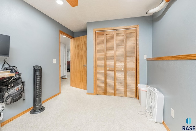 bedroom with carpet, a closet, ceiling fan, and baseboards
