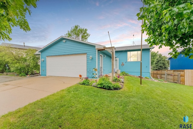 single story home featuring a garage and concrete driveway