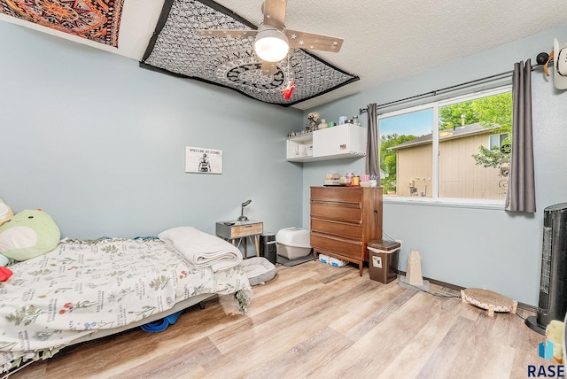 bedroom with wood finished floors and a ceiling fan