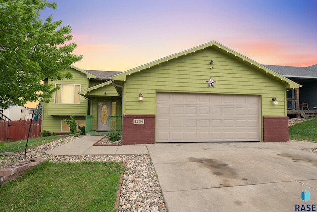 view of front of house featuring driveway, brick siding, and a garage