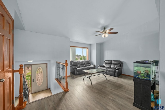 living area featuring ceiling fan, wood finished floors, and baseboards