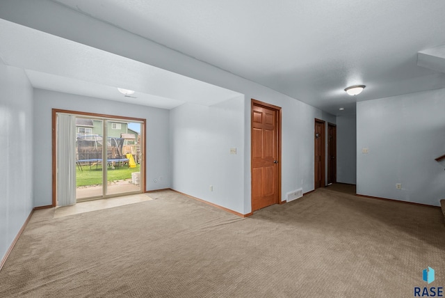 unfurnished room with carpet flooring and baseboards