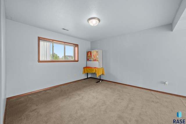 unfurnished room with carpet floors and baseboards