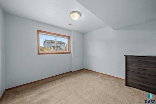 unfurnished bedroom featuring carpet and baseboards