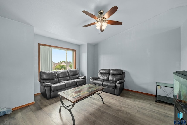 living room featuring a ceiling fan, wood finished floors, and baseboards
