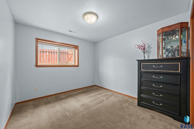 unfurnished bedroom with carpet flooring and baseboards