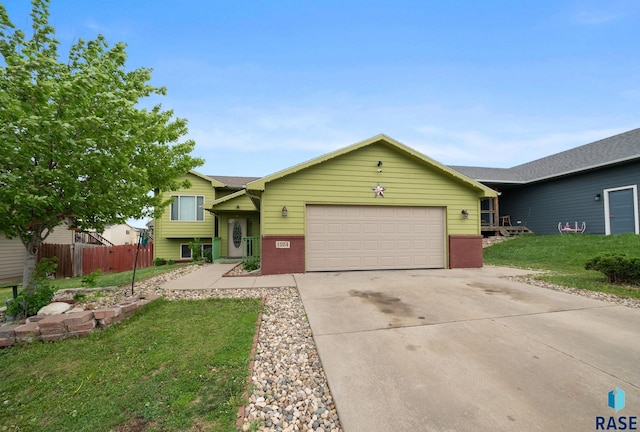 tri-level home with an attached garage, concrete driveway, and brick siding