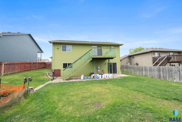 rear view of property with stairs and a patio