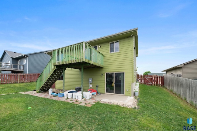 back of property featuring a deck, stairs, and a patio