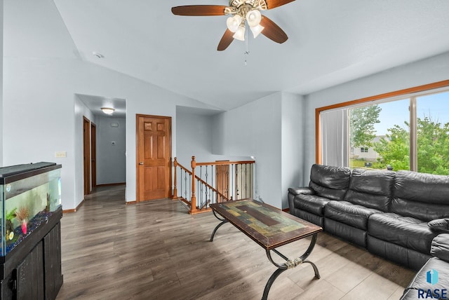 living area featuring lofted ceiling, wood finished floors, and ceiling fan
