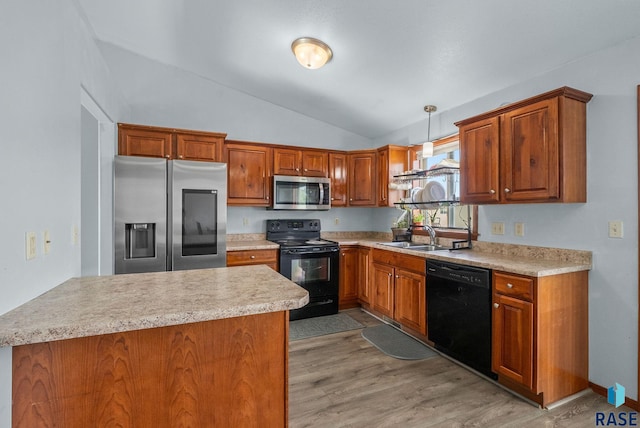 kitchen featuring black appliances, a sink, lofted ceiling, light countertops, and hanging light fixtures