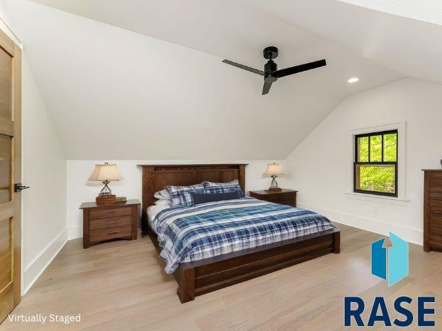 bedroom with lofted ceiling, wood finished floors, baseboards, recessed lighting, and a ceiling fan