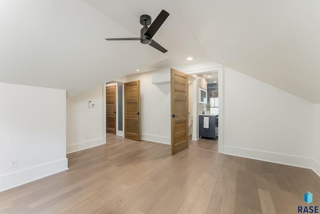additional living space with vaulted ceiling, ceiling fan, light wood finished floors, and baseboards