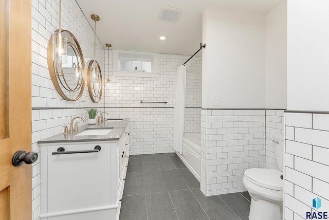 bathroom with tile walls, tile patterned floors, toilet, recessed lighting, and shower / tub combo with curtain