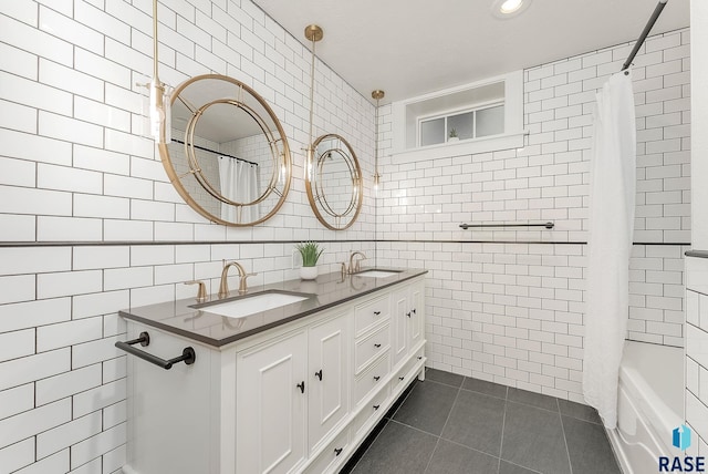 bathroom featuring tile walls, tile patterned floors, and double vanity