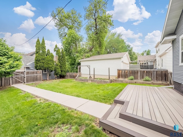 view of yard with a vegetable garden and a wooden deck