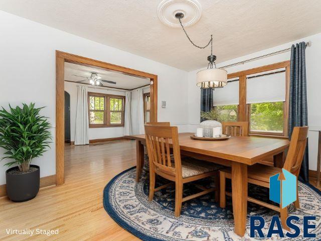 dining room featuring wood finished floors and a chandelier