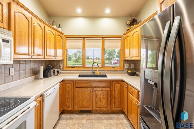 811 Southview Dr, Larchwood, IA 51241 - kitchen with white appliances, a sink, tasteful backsplash, light countertops, and recessed lighting