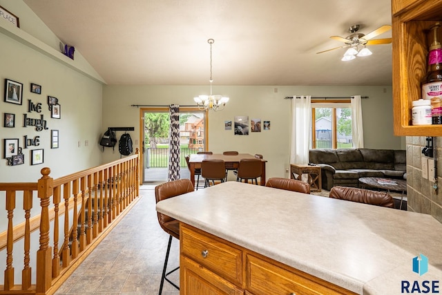 811 Southview Dr, Larchwood, IA 51241 - kitchen with a breakfast bar area, a chandelier, vaulted ceiling, light countertops, and ceiling fan