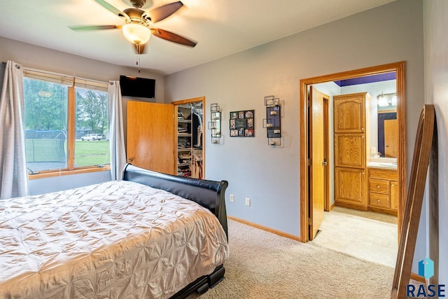 811 Southview Dr, Larchwood, IA 51241 - bedroom with light carpet, a spacious closet, baseboards, a closet, and a ceiling fan