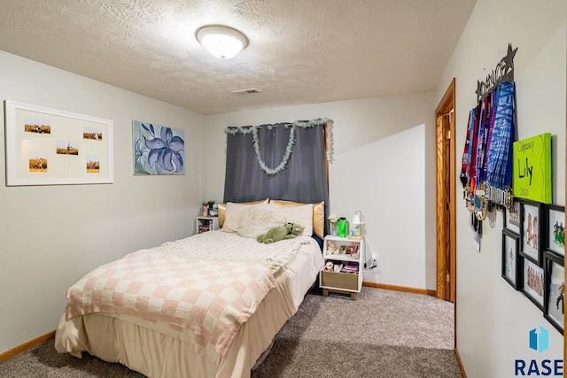 811 Southview Dr, Larchwood, IA 51241 - carpeted bedroom featuring baseboards and a textured ceiling
