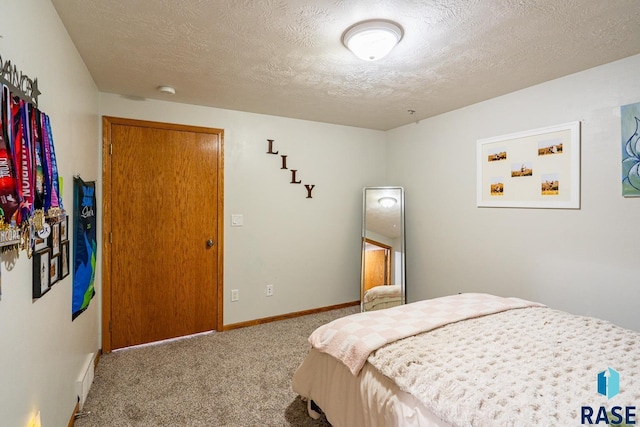 811 Southview Dr, Larchwood, IA 51241 - carpeted bedroom with a textured ceiling and baseboards