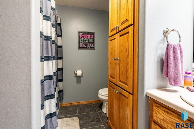 811 Southview Dr, Larchwood, IA 51241 - full bathroom featuring tile patterned flooring, toilet, vanity, a shower with shower curtain, and baseboards