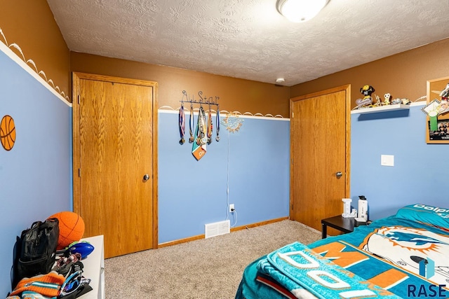 811 Southview Dr, Larchwood, IA 51241 - carpeted bedroom with a textured ceiling and baseboards