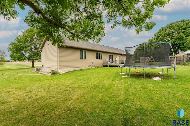 811 Southview Dr, Larchwood, IA 51241 - rear view of house featuring a trampoline, a deck, and cooling unit