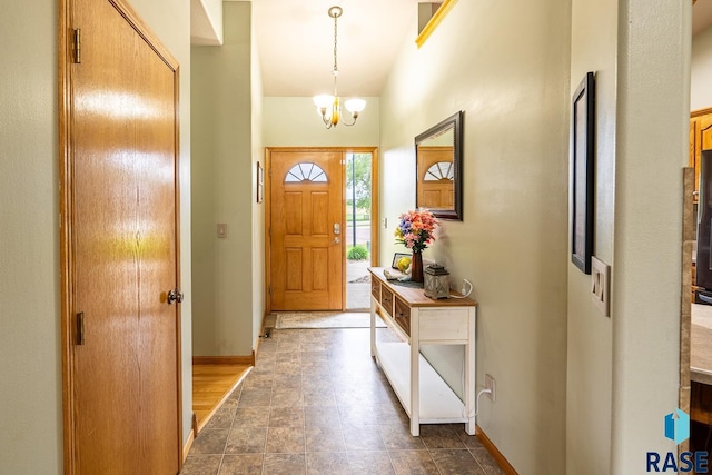 811 Southview Dr, Larchwood, IA 51241 - foyer entrance featuring baseboards and a chandelier