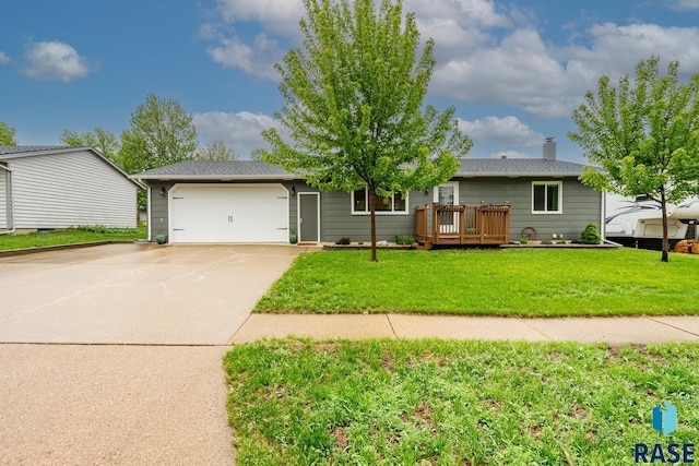 single story home with an attached garage, concrete driveway, and a front yard