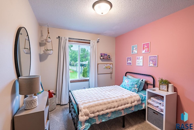 bedroom with carpet flooring and a textured ceiling