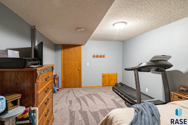 bedroom with carpet and a textured ceiling