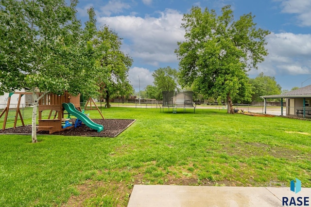 view of yard featuring a trampoline and a playground