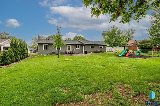 view of yard with a playground and a patio