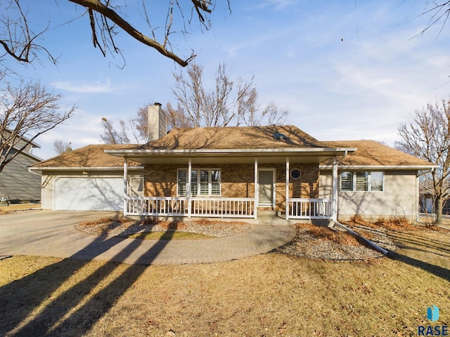 2904 E 52nd St, Sioux Falls, SD 57103 - single story home with a porch, a chimney, concrete driveway, a garage, and brick siding