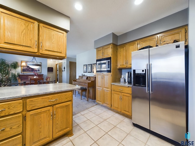 2904 E 52nd St, Sioux Falls, SD 57103 - kitchen with appliances with stainless steel finishes, light countertops, brown cabinetry, light tile patterned floors, and recessed lighting