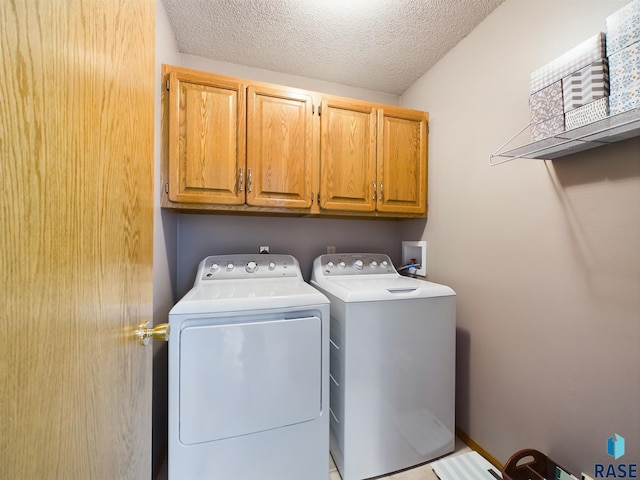 2904 E 52nd St, Sioux Falls, SD 57103 - laundry room with cabinet space, washing machine and clothes dryer, and a textured ceiling