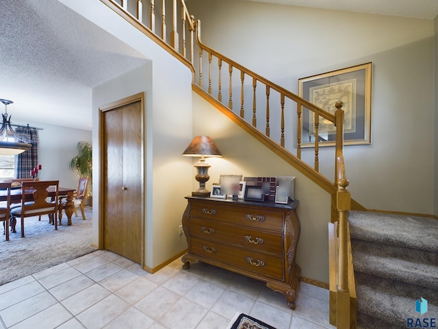 2904 E 52nd St, Sioux Falls, SD 57103 - stairs featuring tile patterned floors, carpet flooring, baseboards, and lofted ceiling