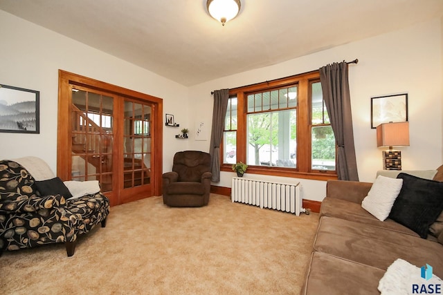 105 N 7th St, Beresford, SD 57004 - living area featuring radiator, carpet flooring, french doors, and baseboards