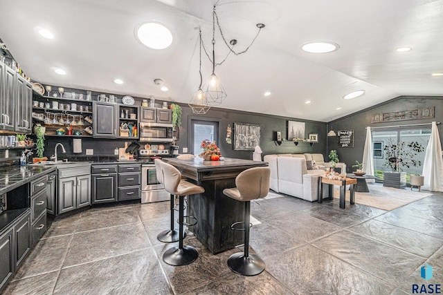 506 SW 8th Ave, Pipestone, MN 56164 - kitchen with appliances with stainless steel finishes, vaulted ceiling, dark countertops, open shelves, and recessed lighting
