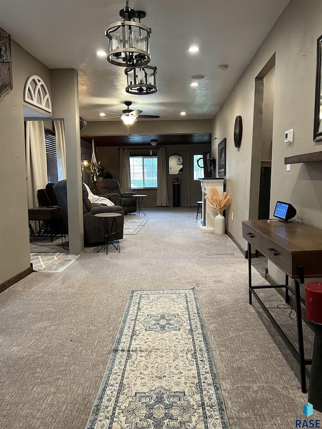 401 W 16th St, Tyndall, SD 57066 - carpeted living area featuring a ceiling fan, a chandelier, recessed lighting, and baseboards
