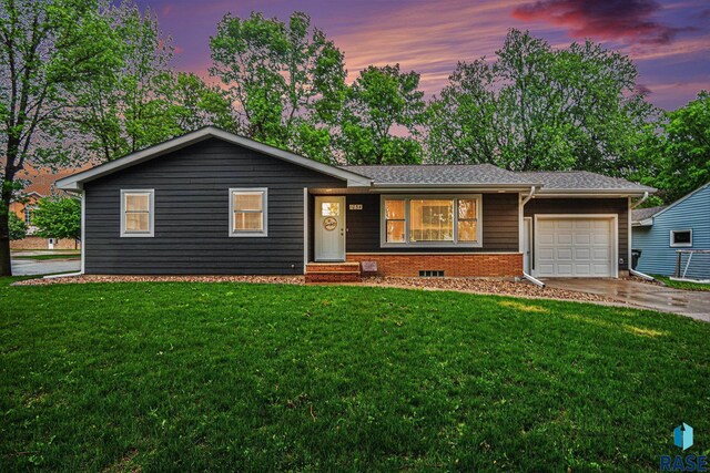 1034 N Elmwood Ave, Luverne, MN 56156 - ranch-style house with a garage, a lawn, and driveway
