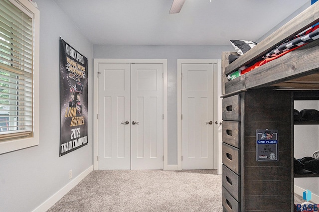 1034 N Elmwood Ave, Luverne, MN 56156 - unfurnished bedroom with carpet, baseboards, a closet, and a ceiling fan