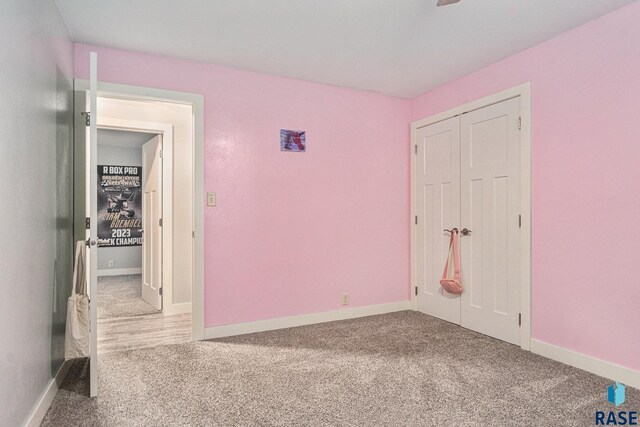1034 N Elmwood Ave, Luverne, MN 56156 - unfurnished bedroom with carpet floors and baseboards